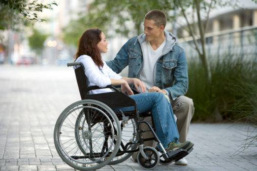 Man with woman in wheelchair